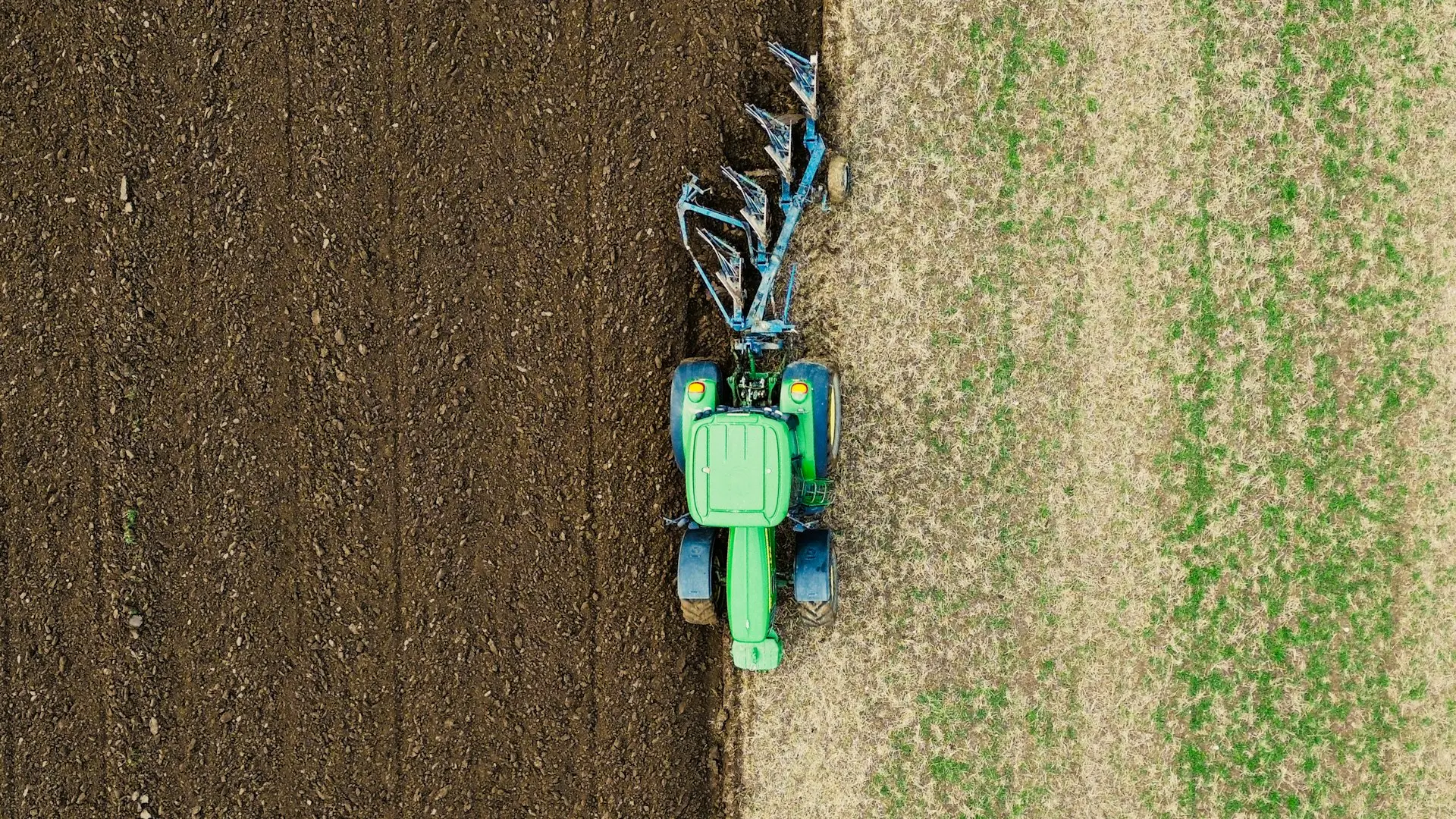 a tractor is plowing a field of grass